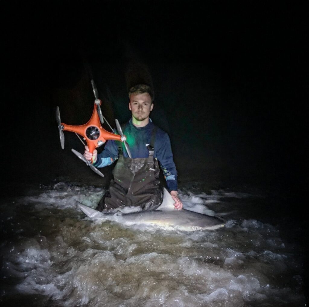 captain with drone and shark